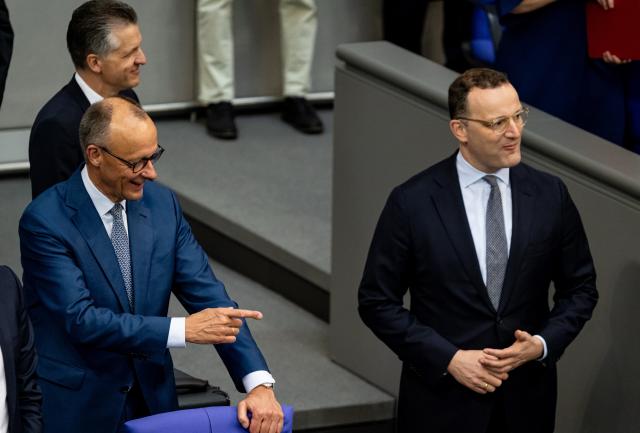 27 June 2025, Berlin: German Chancellor Friedrich Merz (L) and Jens Spahn, leader of the CDU/CSU parliamentary group, take part in the Bundestag session. Topics of the session include a vote on the suspension of family reunification and the first reading of a draft bill to amend the naturalization law. Photo: Fabian Sommer/dpa