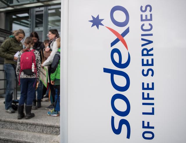FILED - 30 April 2018, Hesse, Ruesselsheim: People stand outside of catering group Sodexo's headquarters in Hesse. Photo: Fabian Sommer/dpa