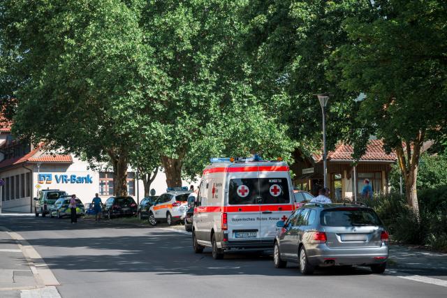 01 July 2025, Bavaria, Mellrichstadt: Ambulances are parked near the regional network operator Überlandwerk Rhoen. A 21-year-old killed a colleague at the company and seriously injured two other employees. Photo: Daniel Vogl/dpa