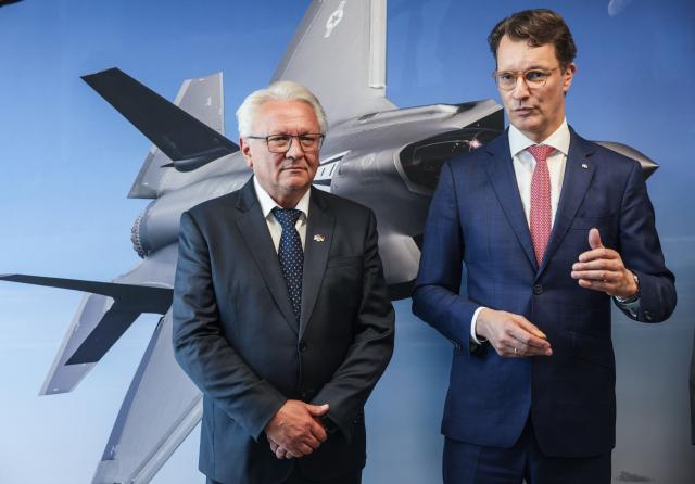 01 July 2025, North Rhine-Westphalia, Weeze: Armin Papperger (L), CEO of the Rheinmetall armaments group, and Hendrik Wüst (CDU, r), Minister President of North Rhine-Westphalia, speak to journalists at the Rheinmetall Aviation Service GmbH plant in Weeze after the Minister President's visit. Rheinmetall is building a factory for military aircraft construction on an area of around 60,000 square meters. Fuselage center sections for the F-35 fighter jet are to be manufactured there from summer 2025. Photo: Oliver Berg/dpa
