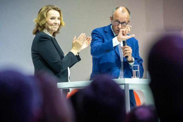 03 July 2025, Berlin: German Chancellor Friedrich Merz (R) speaks alongside Marija Kolak, President of the Federal Association of German Cooperative Banks (BVR) at the Banking Conference of the Federal Association of German Cooperative Banks. Photo: Michael Kappeler/dpa