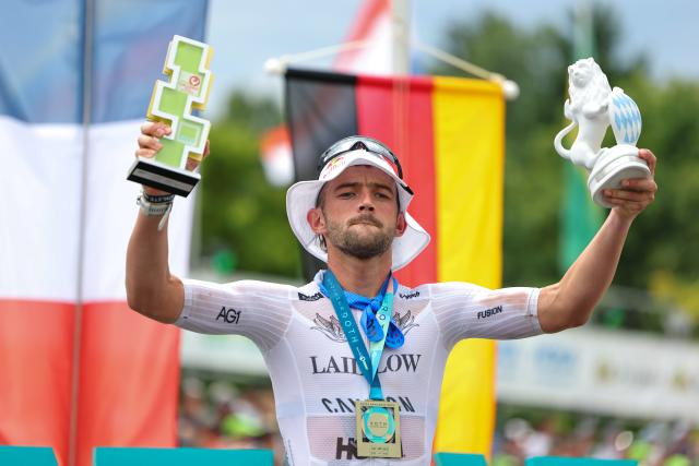 06 July 2025, Bavaria, Roth: French triathlete Sam Laidlow celebrates after the Triathlon Challenge Ironman (3.86 km swim, 180 km bike, 42.195 km run). Photo: Daniel Karmann/dpa
