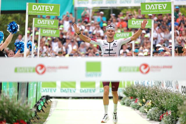 06 July 2025, Bavaria, Roth: German triathlete Jan Stratmann crosses the finish line in third place at the Triathlon Challenge Ironman (3.86 km swim, 180 km bike, 42.195 km run). Photo: Daniel Karmann/dpa