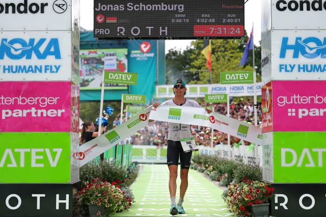 06 July 2025, Bavaria, Roth: German triathlete Jonas Schomburg crosses the finish line in second place at the Triathlon Challenge Ironman (3.86 km swim, 180 km bike, 42.195 km run). Photo: Daniel Karmann/dpa