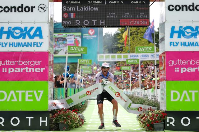 06 July 2025, Bavaria, Roth: French triathlete Sam Laidlow crosses the finish line to win the Triathlon Challenge Ironman (3.86 km swim, 180 km bike, 42.195 km run). Photo: Daniel Karmann/dpa
