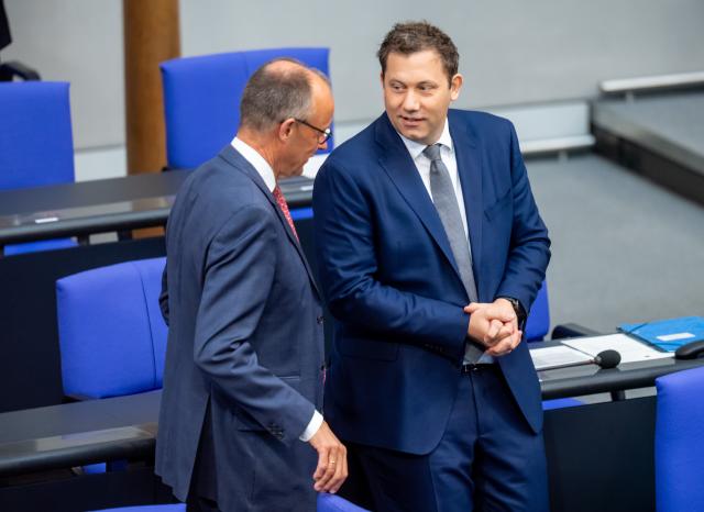 08 July 2025, Berlin: Lars Klingbeil (R), German Minister of Finance, speaks with German Chancellor Friedrich Merz in the Bundestag during budget consultations on the introduction of the draft federal budget for 2025. Photo: Michael Kappeler/dpa