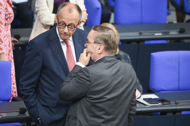 09 July 2025, Berlin: German Chancellor Friedrich Merz (L) speaks with Boris Pistorius, German Minister of Defense, before the general debate on the budget in the plenary session of the Bundestag. The general debate is the highlight of the budget week in the Bundestag. Photo: Katharina Kausche/dpa