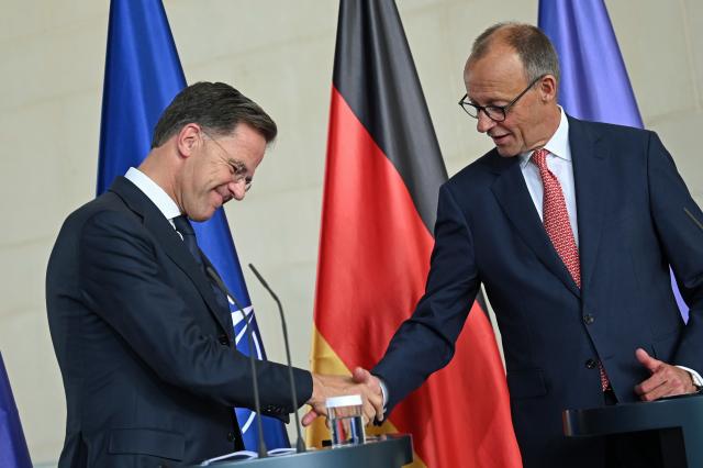 09 July 2025, Berlin: German Chancellor Friedrich Merz (R) and NATO Secretary General Mark Rutte shake hands during a press conference in the Chancellery after their meeting. Photo: Niklas Treppner/dpa