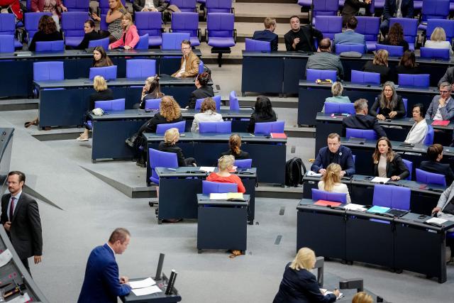 11 July 2025, Berlin: Parts of the parliamentary group of the Left Party and the SPD turn their backs on speaker Martin Sichert of the AfD in the Bundestag plenary during the debate on the 30th anniversary of the Srebrenica genocide. Photo: Kay Nietfeld/dpa