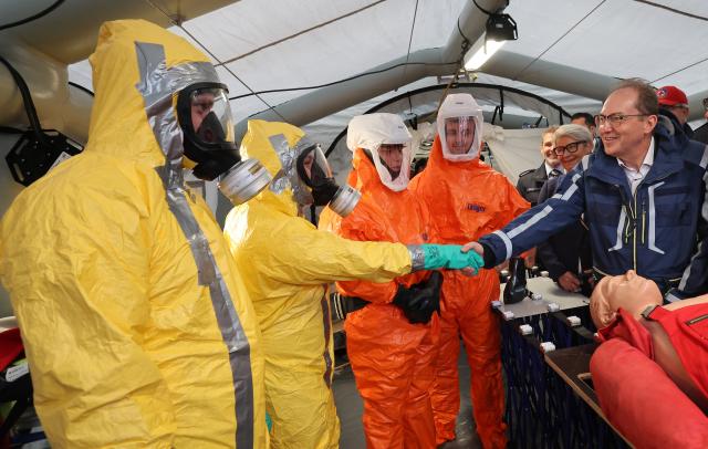 12 July 2025, Mecklenburg-Western Pomerania, Rostock: Alexander Dobrindt, German Minister of the Interior, learns about firefighter operations involving hazardous substances at the nationwide Civil Protection Day in the Hanseatic city's city harbor. Photo: Bernd Wüstneck/dpa