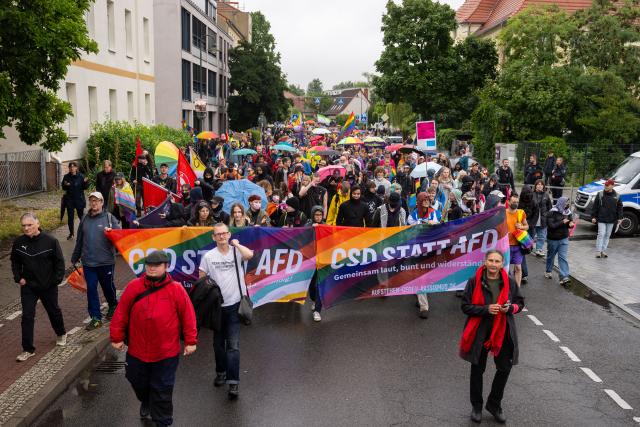 12 July 2025, Brandenburg, Bernau: Participants walk through Bernau during a Christopher Street Day demonstration. Photo: Christophe Gateau/dpa