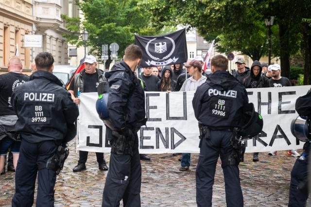 12 July 2025, Brandenburg, Bernau: Participants stand at a counter-demonstration for Christopher Street Day in Bernau. Photo: Christophe Gateau/dpa
