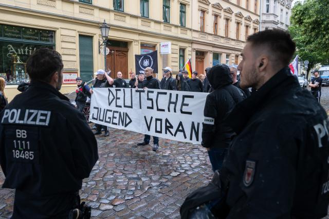 12 July 2025, Brandenburg, Bernau: Participants stand at a counter-demonstration to Christopher Street Day in Bernau with a banner reading "German youth ahead". Photo: Christophe Gateau/dpa