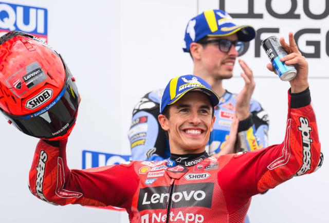 13 July 2025, Saxony, Hohenstein-Ernstthal: Spanish motorcycle racer Marc Marquez of the Ducati Lenovo Team celebrates on the podium after winning the MotoGP race at the German Grand Prix at Sachsenring, alongside second-placed fellow Spaniard Alex Marquez of the Gresini Racing MotoGP Team (Ducati). Photo: Robert Michael/dpa