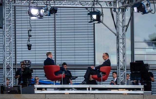 13 July 2025, Berlin: Germany's Chancellor Friedrich Merz (R) sits next to Markus Preiss, head of the ARD Capital Studio, during the ARD summer interview. In the live program *Bericht aus Berlin*, Merz discusses current political issues. Photo: Michael Kappeler/dpa