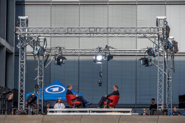 13 July 2025, Berlin: Germany's Chancellor Friedrich Merz (R) sits next to Markus Preiss, head of the ARD Capital Studio, during the ARD summer interview. In the live program *Bericht aus Berlin*, Merz discusses current political issues. Photo: Michael Kappeler/dpa