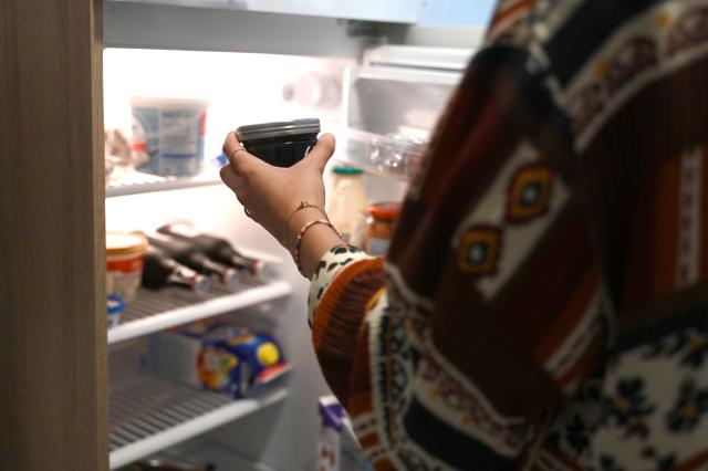 FILED - 03 July 2024, Berlin: A woman takes a jar of jam out of the fridge at home. Roughly 17 million people in Germany were living alone last year, or more than one in five, according to data from the Federal Statistical Office released on Wednesday. Photo: Alicia Windzio/dpa