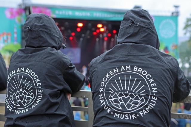 31 July 2025, Saxony-Anhalt, Elend: Visitors stand in front of the stage at the "Rocken am Brocken" music festival. Photo: Matthias Bein/dpa