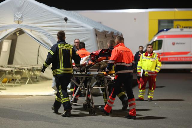 02 August 2025, Saxony-Anhalt, Quedlinburg: Emergency services bring residents of a retirement and nursing home in Quedlinburg to a supply tent, after a fire broke off and the power supply in the building was cut off. Around 49 residents had to be evacuated during the night. The residents were taken to neighboring facilities. Photo: Matthias Bein/dpa