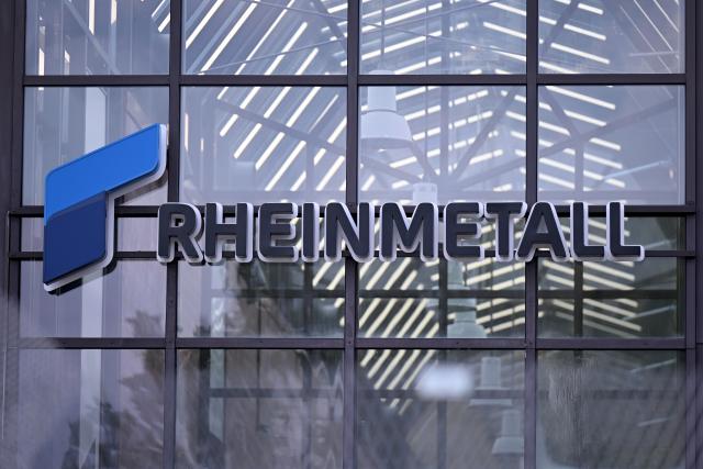 FILED - 27 August 2025, Lower Saxony, Unterluess: The logo of the Rheinmetall armaments group can be seen behind a fence at the entrance to a Rheinmetall plant. Photo: Wolf von Dewitz/dpa