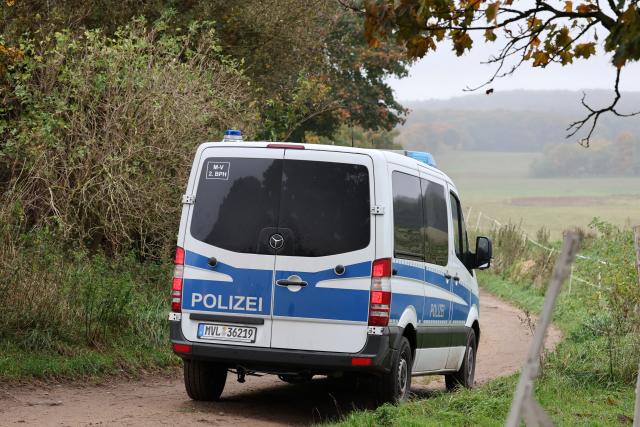 14 October 2025, Mecklenburg-Western Pomerania, Klein Upahl: A police vehicle drives to the scene where a child's body was found. During the search for missing eight-year-old Fabian from Güstrow, emergency services have found the child's body in a forest near Klein Upahl. Photo: Bernd Wüstneck/dpa