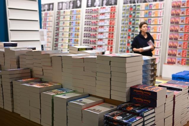14 October 2025, Hesse, Frankfurt/Main: Paperbacks are stacked at the DTV Verlag stand at the Frankfurt Book Fair during set-up. Photo: Arne Dedert/dpa