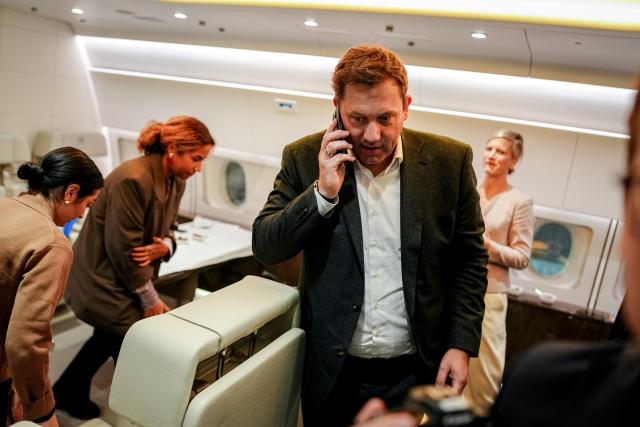 14 October 2025, Brandenburg, Schoenefeld: Lars Klingbeil, Germany's Minister of Finance, Vice-Chancellor, speaks on the phone next to Reem Alabali Radovan, Germany's Minister for Economic Cooperation and Development, on the military section of BER Berlin-Brandenburg Airport in the Air Force Airbus A350 for the flight to Washington for the annual meeting of the International Monetary Fund and the World Bank. Photo: Kay Nietfeld/dpa