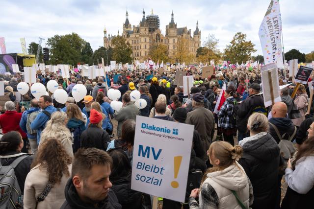 15 October 2025, Mecklenburg-Western Pomerania, Schwerin: Demonstrators hold placards during a protest organized by social organizations under the slogan "Respect instead of red pencil - MV remains social!". The protest event is directed against the state government's austerity plans, in particular against cuts in aid for people with disabilities. Photo: Ulrich Perrey/dpa