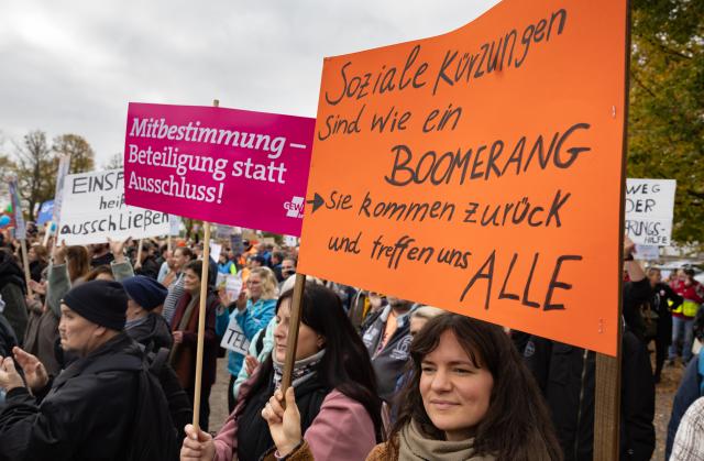 15 October 2025, Mecklenburg-Western Pomerania, Schwerin: Demonstrators hold placards during a protest organized by social organizations under the slogan "Respect instead of red pencil - MV remains social!". The protest event is directed against the state government's austerity plans, in particular against cuts in aid for people with disabilities. Photo: Ulrich Perrey/dpa