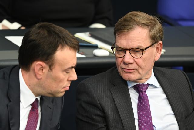 15 October 2025, Berlin: Johann Wadephul (R), German Foreign Minister, speaks to Nils Schmid, Parliamentary State Secretary at the German Ministry of Defense, during the 33rd plenary session of the 21st legislative period at the German Bundestag. Photo: Niklas Graeber/dpa
