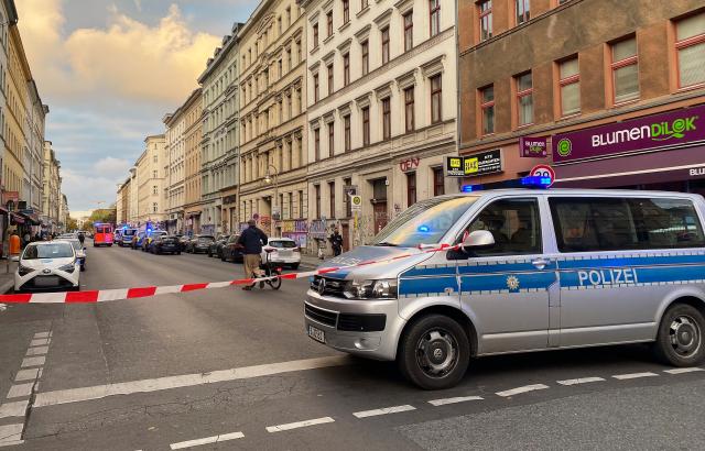 15 October 2025, Berlin: A police vehicle stands on a street in Berlin-Kreuzberg during a large-scale operation. Two people have been injured following an exchange of gunfire between several people in Berlin-Kreuzberg. Photo: Anja Mia Neumann/dpa