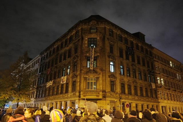 15 October 2025, Saxony, Leipzig: Young people gather in front of a vacant house in the east of Leipzig, which is being secured by the police. Left-wing activists have occupied the building. Photo: Sebastian Willnow/dpa