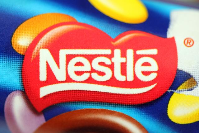 FILED - 17 October 2013, Hesse, Wiesbaden: The logo of food producer Nestle is a pictured on a package of 'Smarties' in Wiesbaden, Germany, 17 October 2013. Photo: picture alliance / dpa
