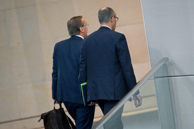 16 October 2025, Berlin: Boris Pistorius (L), German Minister of Defense, and German Chancellor Friedrich Merz leave the Bundestag together after the end of the debate following the government statement on the EU summit. In addition to the debate following Chancellor Merz's government statement, Parliament also deals with pension legislation and the Military Service Modernization Act. Photo: Niklas Graeber/dpa