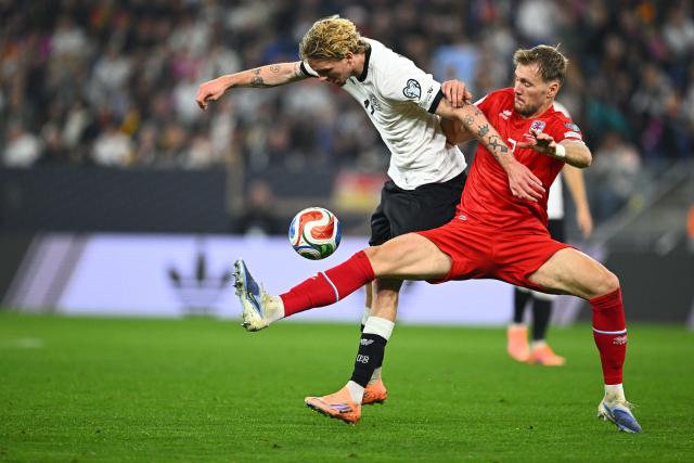 FILED - 10 October 2025, Baden-Wuerttemberg, Sinsheim: Germany's Nick Woltemade and Luxembourg's Enes Mahmutovic battle for the ball during the FIFA World Cup European Qualifier soccer match between Germany and Luxembourg at the PreZero Arena. Photo: Tom Weller/dpa