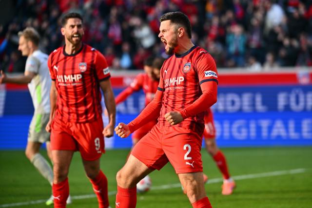 18 October 2025, Baden-Wuerttemberg, Heidenheim: Heidenheim's Marnon Busch (R) celebrates scoring his side's first goal with teammate Stefan Schimmer during the German Bundesliga soccer match between 1. FC Heidenheim and Werder Bremen at Voith-Arena. Photo: Jan-Philipp Strobel/dpa - WICHTIGER HINWEIS: Gemäß den Vorgaben der DFL Deutsche Fußball Liga bzw. des DFB Deutscher Fußball-Bund ist es untersagt, in dem Stadion und/oder vom Spiel angefertigte Fotoaufnahmen in Form von Sequenzbildern und/oder videoähnlichen Fotostrecken zu verwerten bzw. verwerten zu lassen.
