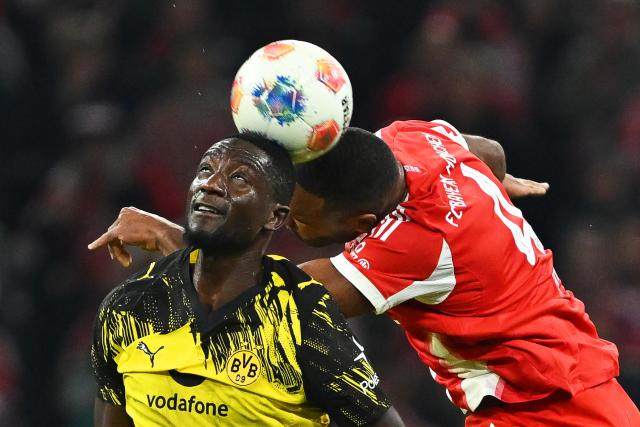 18 October 2025, Bavaria, Munich: Bayern Munich's Jonathan Tah (R) and Borussia Dortmund's Serhou Guirassy battle for the ball during the German Bundesliga soccer match between Bayern Munich and Borussia Dortmund at Allianz Arena. Photo: Sven Hoppe/dpa - IMPORTANT NOTICE: DFL and DFB regulations prohibit any use of photographs as image sequences and/or quasi-video.