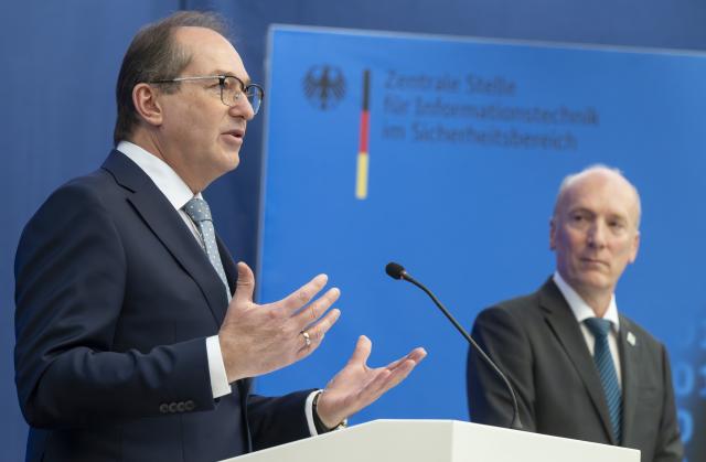 20 October 2025, Bavaria, Munich: German Minister of the Interior Alexander Dobrindt (L) and Wilfried Karl, President of the Central Office for Information Technology in the Security Sector, show off an FPV self-built drone during Dobrindt's visit to the Central Office for Information Technology in the Security Sector (ZITiS). Photo: Peter Kneffel/dpa