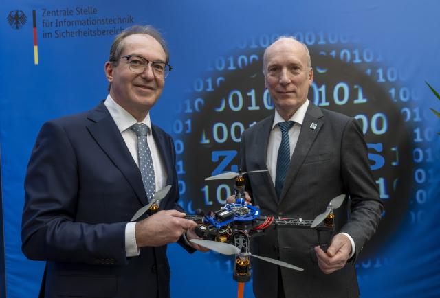 20 October 2025, Bavaria, Munich: German Minister of the Interior Alexander Dobrindt (L) and Wilfried Karl, President of the Central Office for Information Technology in the Security Sector, show off an FPV self-built drone during Dobrindt's visit to the Central Office for Information Technology in the Security Sector (ZITiS). Photo: Peter Kneffel/dpa