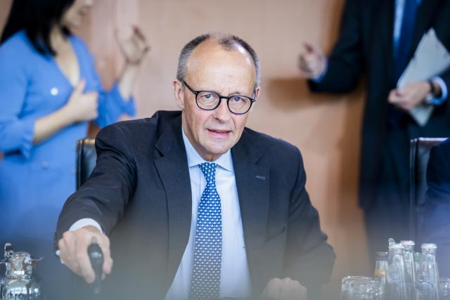 22 October 2025, Berlin: Germany's Chancellor Friedrich Merz rings the bell at the start of the German Cabinet meeting in the Chancellery. Photo: Christoph Soeder/dpa
