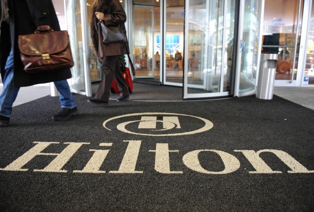 FILED - 29 January 2012, Bavaria, Munich: Two men come out of the Hilton Hotel am Tucherpark. Photo: Andreas Gebert/dpa