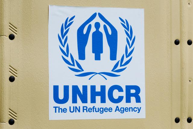 FILED - 17 September 2021, Berlin: The United Nations High Commissioner for Refugees (UNHCR) logo is stuck to a UNHCR self-built hut. Photo: Annette Riedl/dpa