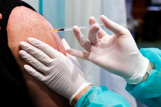 FILED - 01 February 2022, Berlin: A doctor inoculates a patient with a vaccine against Coronavirus. Photo: Carsten Koall/dpa