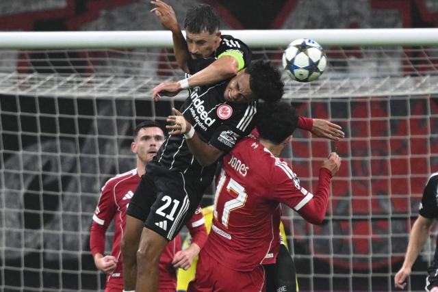 22 October 2025, Hesse, Frankfurt_Main: Eintracht Frankfurt's Robin Koch (L) and Nathaniel Brown (C) battle for the ball with Liverpool's Curtis Jones during the UEFA Champions League soccer match between Eintracht Frankfurt and Liverpool FC at the Deutsche Bank Park. Photo: Arne Dedert/dpa