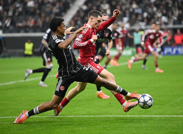 22 October 2025, Hesse, Frankfurt_Main: Eintracht Frankfurt's Nathaniel Brown (L) and Liverpool's Florian Wirtz battle for the ball during the UEFA Champions League soccer match between Eintracht Frankfurt and Liverpool FC at the Deutsche Bank Park. Photo: Arne Dedert/dpa