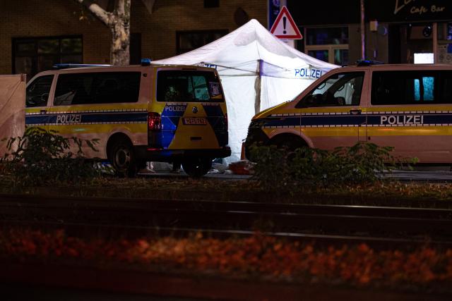 22 October 2025, Lower Saxony, Hanover: Emergency vehicles are parked at a crime scene in front of a police tent, after one person was killed and several others injured in an incident in Hanover. Photo: Moritz Frankenberg/dpa