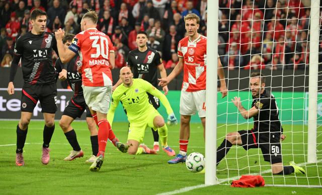 23 October 2025, Rhineland-Palatinate, Mainz: Zrinjski Mostar's Kerim Memija saves on the line against FSV Mainz's Silvan Widmer during the UEFA Europa Conference League match between FSV Mainz 05 and Zrinjski Mostar at Mewa Arena. Photo: Torsten Silz/dpa