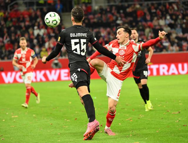 23 October 2025, Rhineland-Palatinate, Mainz: FSV Mainz's Paul Nebel and Zrinjski Mostar's Duje Dujmovic in action during the UEFA Europa Conference League match between FSV Mainz 05 and Zrinjski Mostar at Mewa Arena. Photo: Torsten Silz/dpa