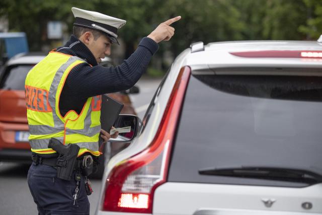 FILED - 22 May 2019, Hessen, Frankfurt/Main: A policeman checks the papers of a car driver who was pulled over for his driving style. Road deaths in the European Union reached nearly 20,000 last year and the bloc is determined to significantly curb that number by 2050. Photo: Boris Roessler/dpa