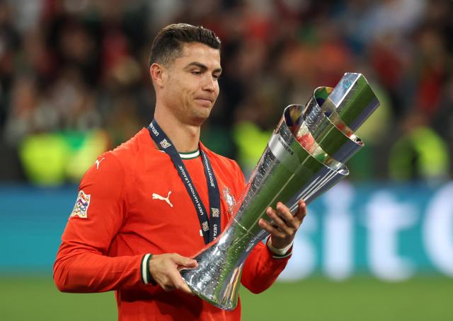 FILED - 09 June 2025, Bavaria, Munich: Portugal's Christiano Ronaldo holds the trophy after his team won the UEFA Nations League at the Allianz Arena. A study conducted by two university researchers in Spain, focusing on productivity and performance, concluded that Portuguese star Cristiano Ronaldo was more productive and influential at Real Madrid than Argentine star Lionel Messi at Barcelona. Photo: Christian Charisius/dpa